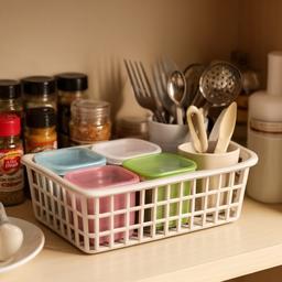 Küchenorganizer und Korb für Utensilien neben Gewürzen und kleinen Behältern